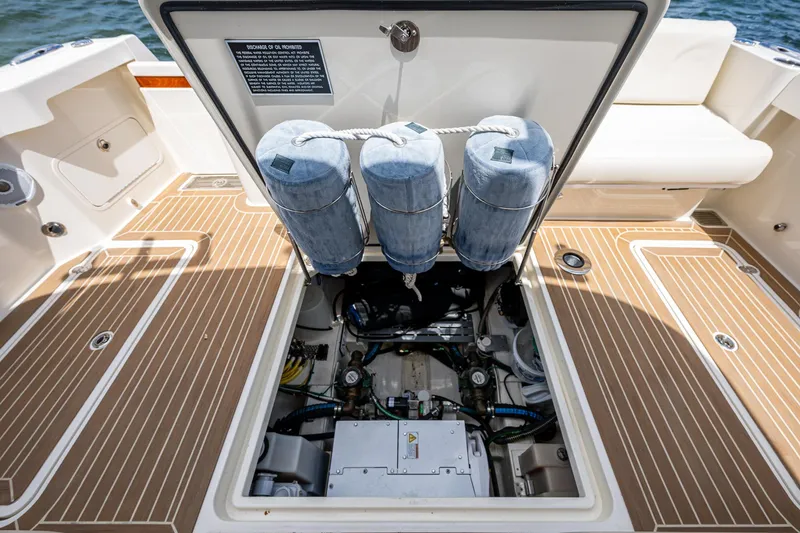 Slide: The Image of Engine compartment of 2021 Hinckley Sport Boat 40 X, showcasing mechanical components and storage. - 31