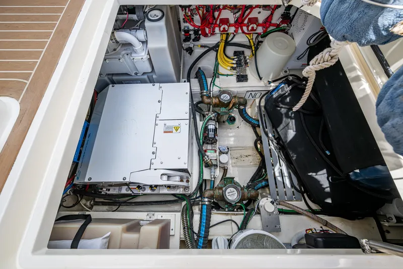 Slide: The Image of Engine compartment of a 2021 Hinckley Sport Boat 40 X, showcasing mechanical components and wiring. - 32