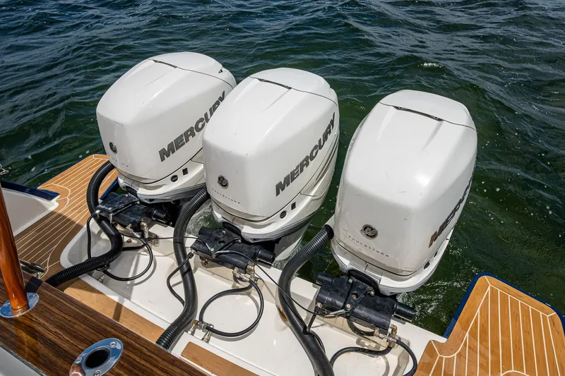 Slide: The Image of 2021 Hinckley Sport Boat 40 X with triple Mercury outboard engines on water. - 4