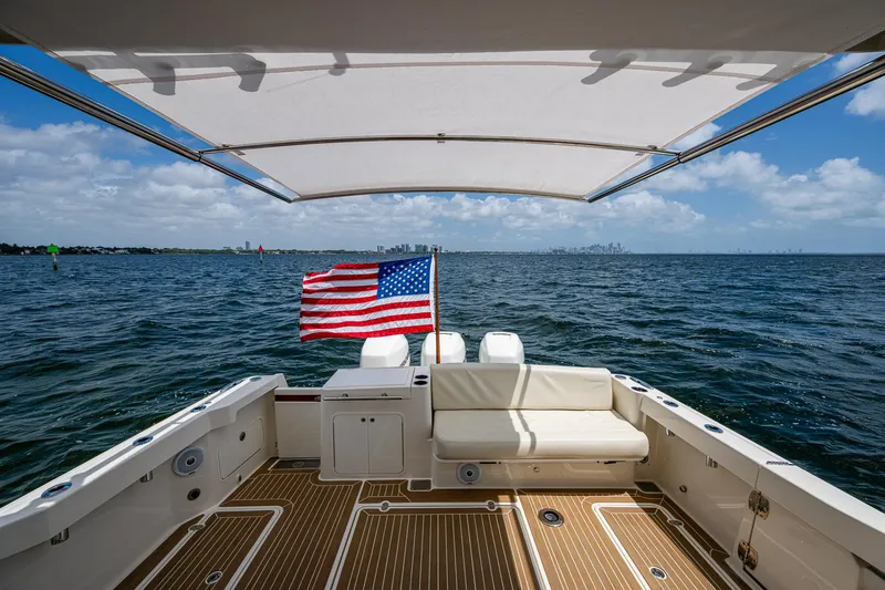 Slide: The Image of 2021 Hinckley Sport Boat 40 X on open water, American flag, sunny day. - 5