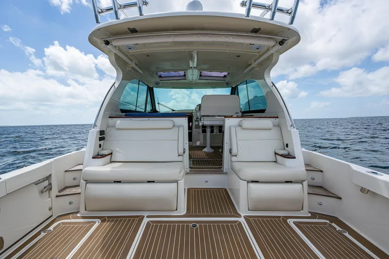 Slide: The Image of 2021 Hinckley Sport Boat 40 X interior with white seating and ocean view. - 9