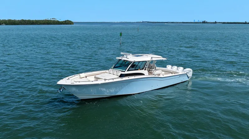 Slide: The Image of 2023 Grady-White Canyon 456 boat cruising on open water. - 11