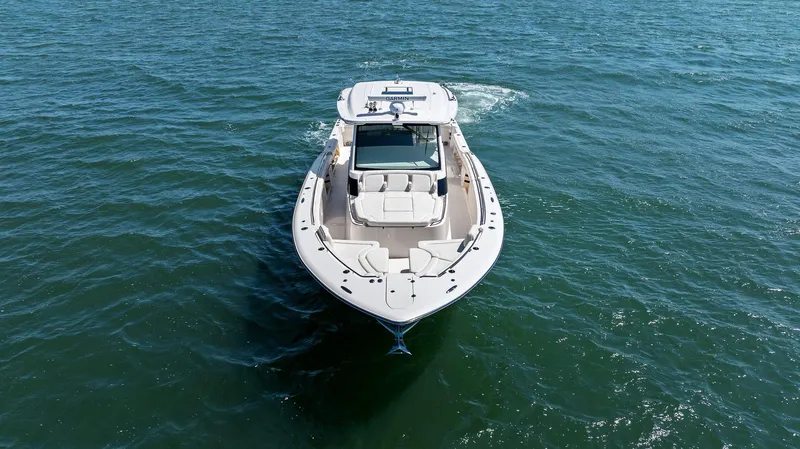 Slide: The Image of 2023 Grady-White Canyon 456 boat cruising on open water. - 12