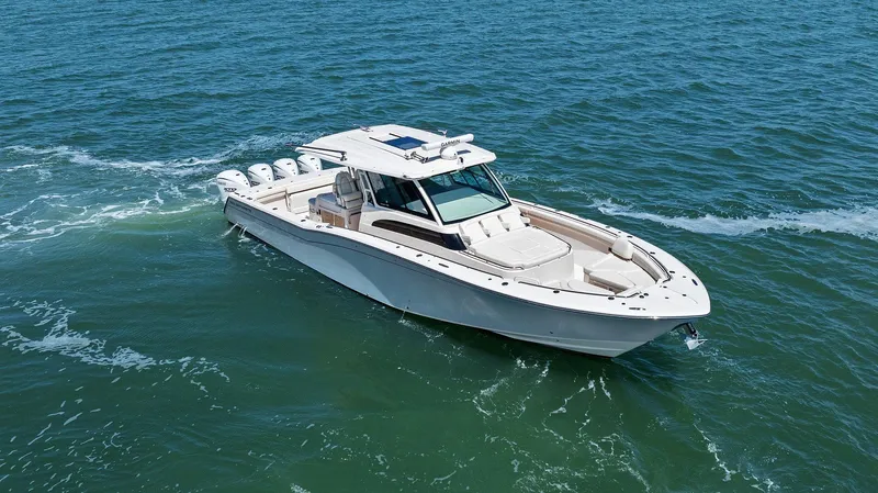 Slide: The Image of 2023 Grady-White Canyon 456 boat cruising on open water. - 13