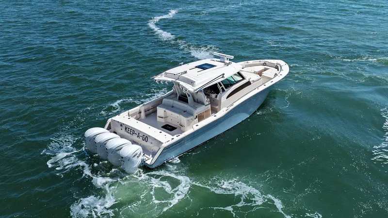 Slide: The Image of 2023 Grady-White Canyon 456 boat cruising on open water, rear view. - 15