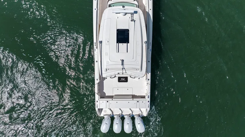 Slide: The Image of 2023 Grady-White Canyon 456 boat, aerial view, cruising on green water. - 17