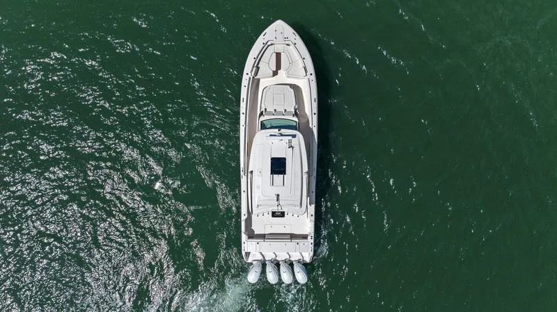 Slide: The Image of 2023 Grady-White Canyon 456 boat cruising on open water, aerial view. - 18