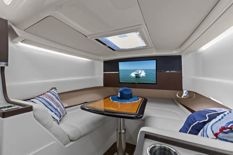 Slide: The Image of Luxurious interior of 2023 Grady-White Canyon 456 boat with seating and table. - 2