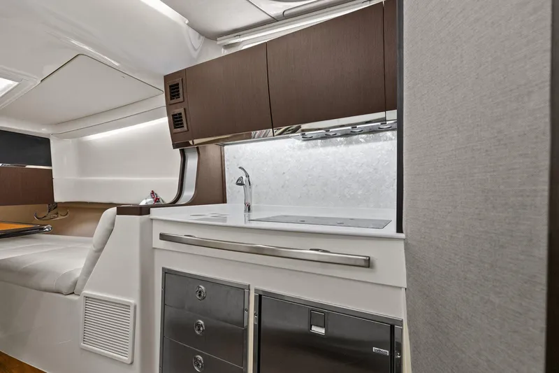 Slide: The Image of 2023 Grady-White Canyon 456 interior with modern kitchenette and sleek cabinetry. - 23