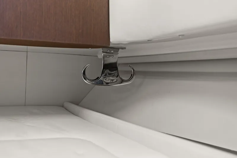 Slide: The Image of 2023 Grady-White Canyon 456 interior detail with chrome hook and white upholstery. - 28