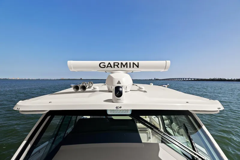 Slide: The Image of 2023 Grady-White Canyon 456 boat with Garmin radar on open water. - 30