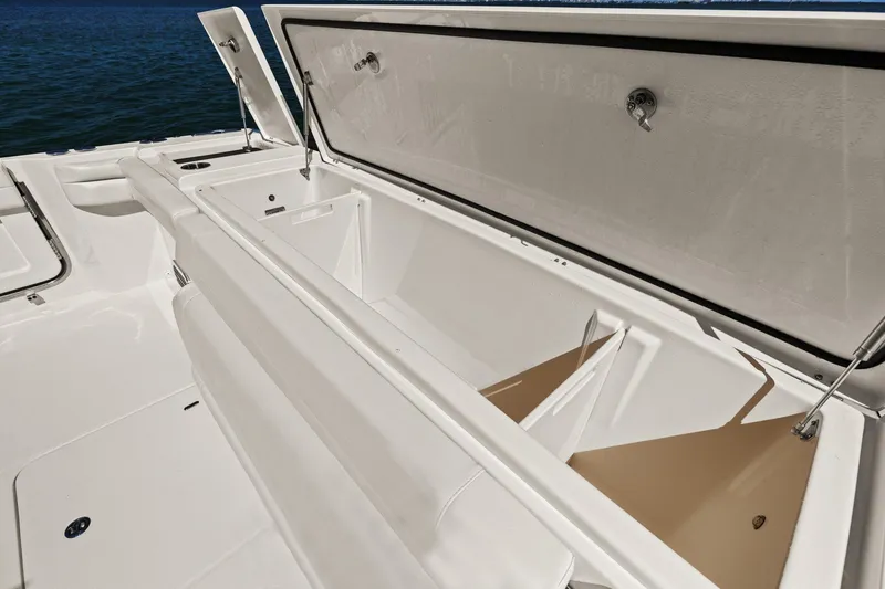 Slide: The Image of 2023 Grady-White Canyon 456 boat storage compartment open on deck. - 35
