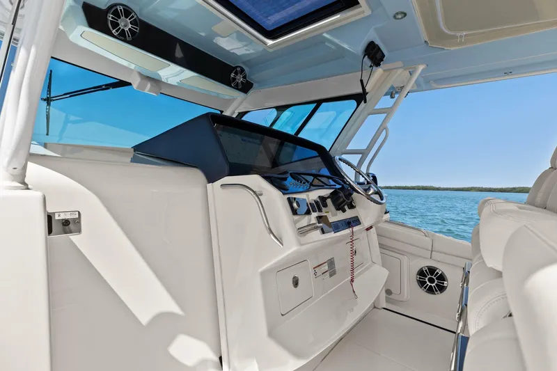 Slide: The Image of 2023 Grady-White Canyon 456 boat interior with modern dashboard and ocean view. - 42
