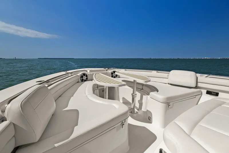 Slide: The Image of 2023 Grady-White Canyon 456 boat interior with white seating and ocean view. - 46