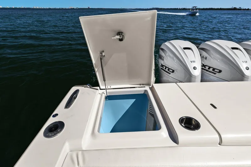 Slide: The Image of 2023 Grady-White Canyon 456 boat with open storage compartment and powerful outboard engines. - 48