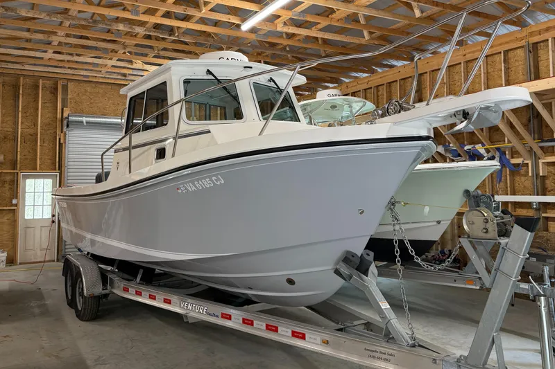 Slide: The Image of 2022 Steiger Craft 255 DV MIAMI boat on trailer in wooden garage. - 0