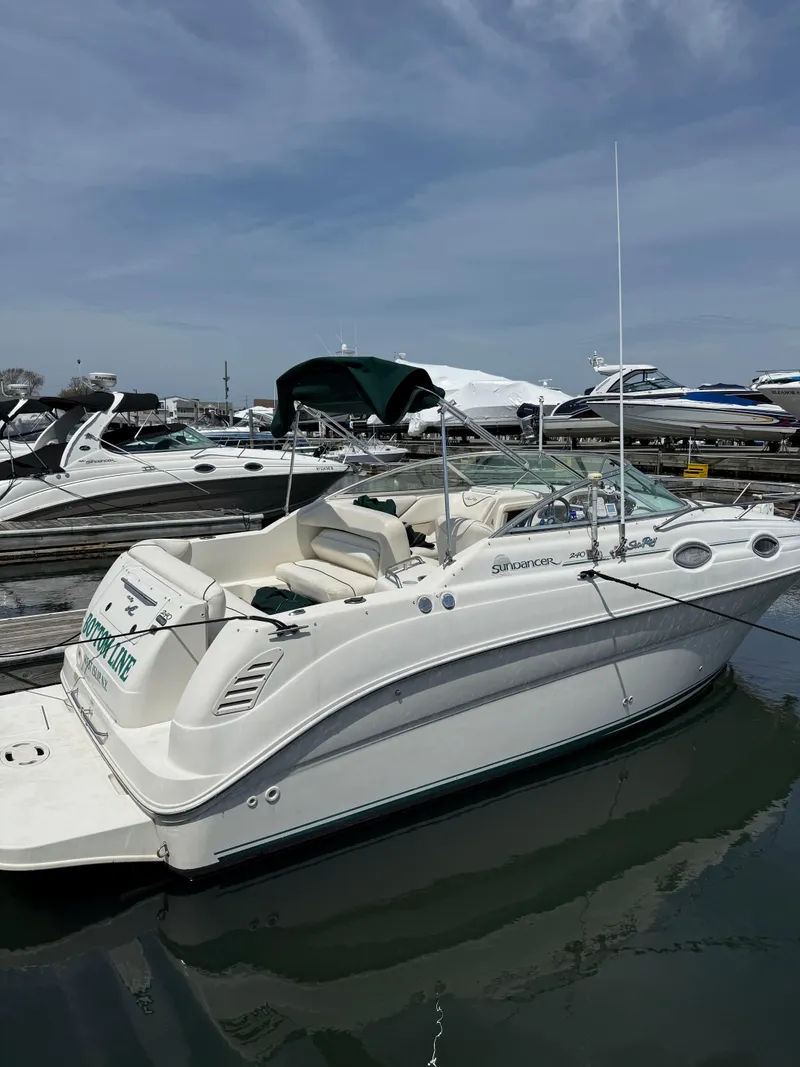 Slide: The Image of 2000 Sea Ray 240 Sundancer boat docked at marina under clear sky. - 12