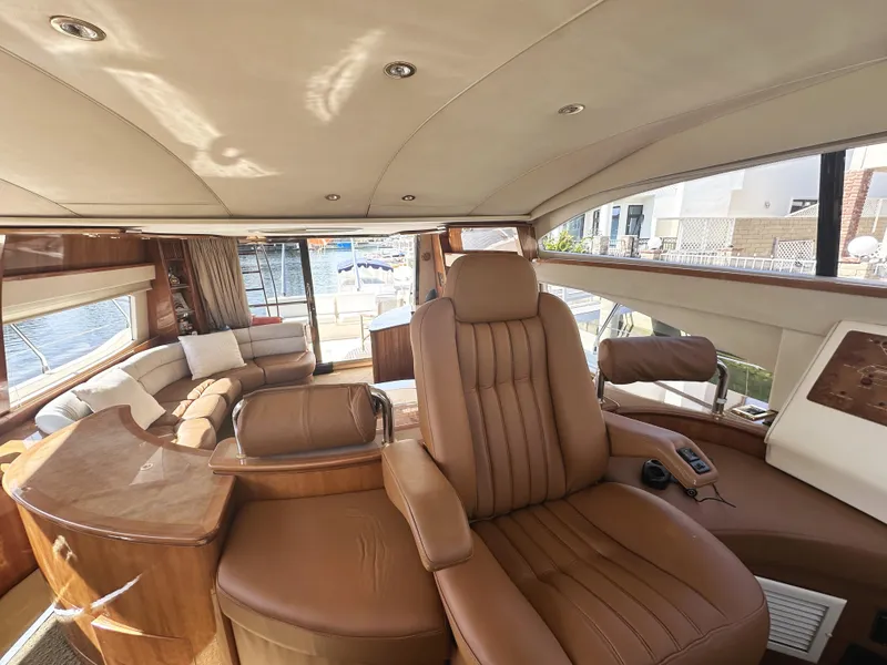 Slide: The Image of Luxurious interior of a 1996 Azimut 54 yacht with leather seating and panoramic windows. - 13
