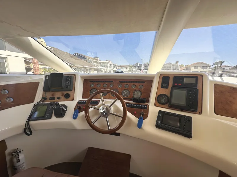 Slide: The Image of 1996 Azimut 54 yacht helm with navigation instruments and wooden steering wheel. - 18