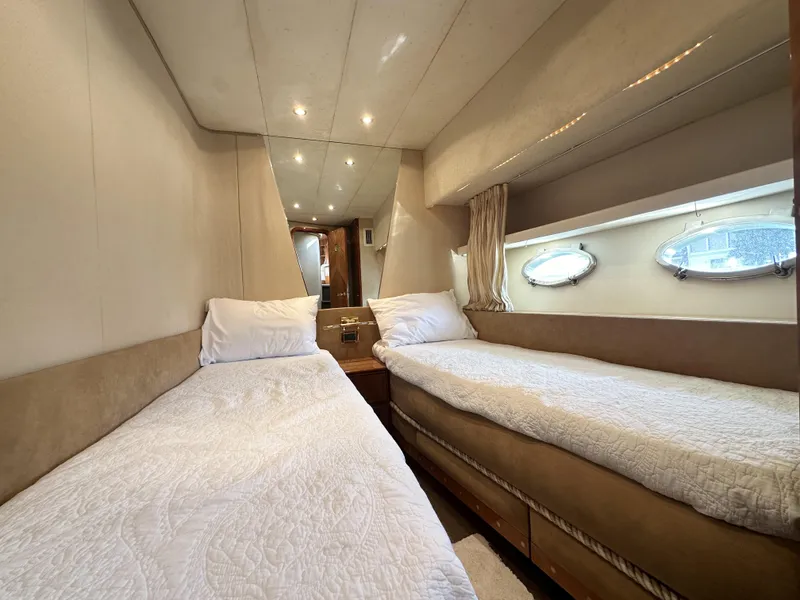 Slide: The Image of Twin cabin interior of 1996 Azimut 54 yacht with cozy beds and porthole windows. - 21