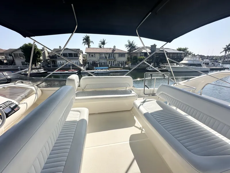 Slide: The Image of 1996 Azimut 54 yacht interior with white seating and waterfront view. - 35