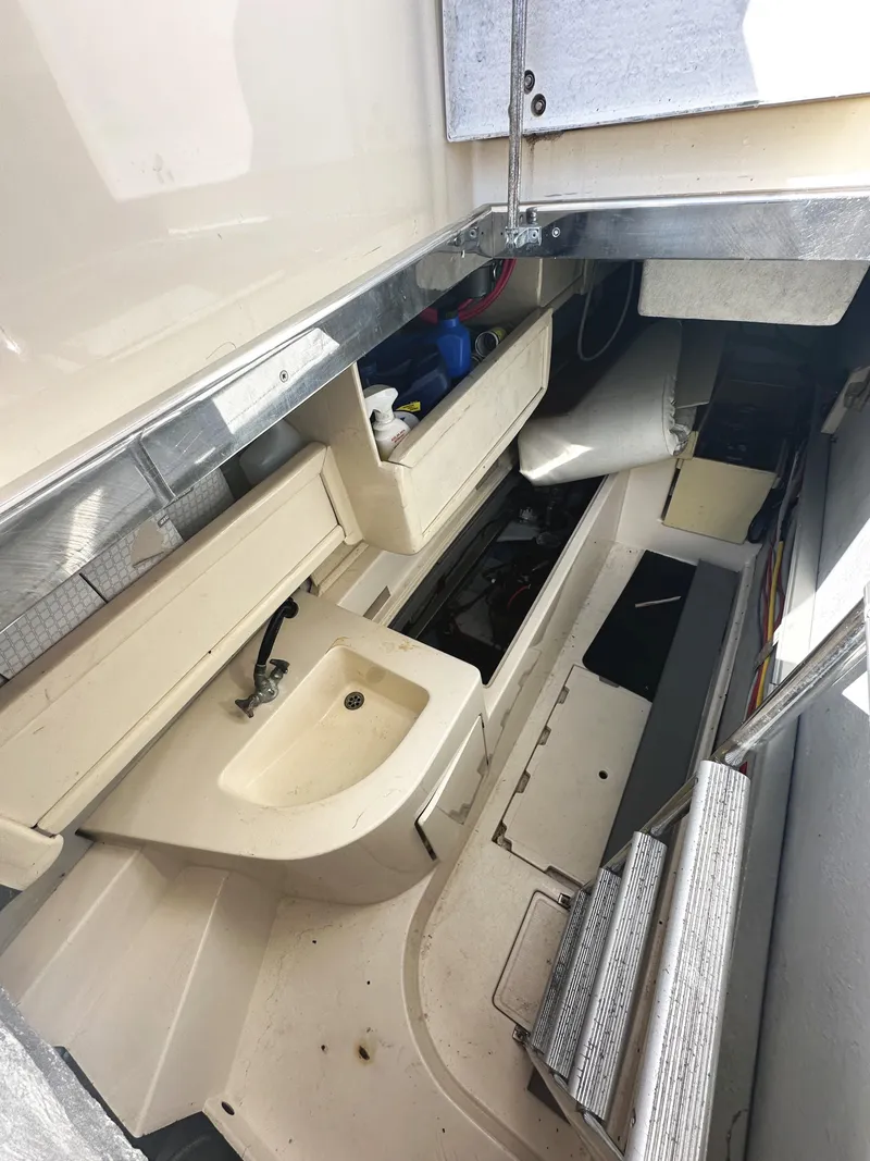 Slide: The Image of Interior view of a 1996 Azimut 54 yacht, featuring a compact sink and storage area. - 40