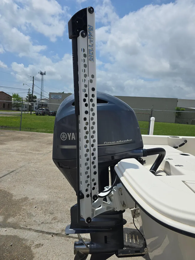 Slide: The Image of 2021 Carolina Skiff 21 LS with Yamaha outboard motor, docked under cloudy sky. - 11