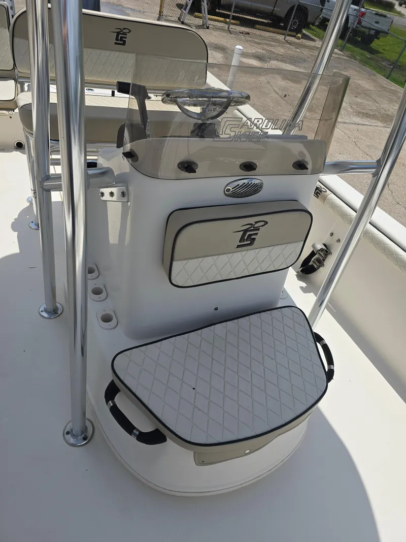 Slide: The Image of 2021 Carolina Skiff 21 LS boat console with seating and steering wheel. - 6