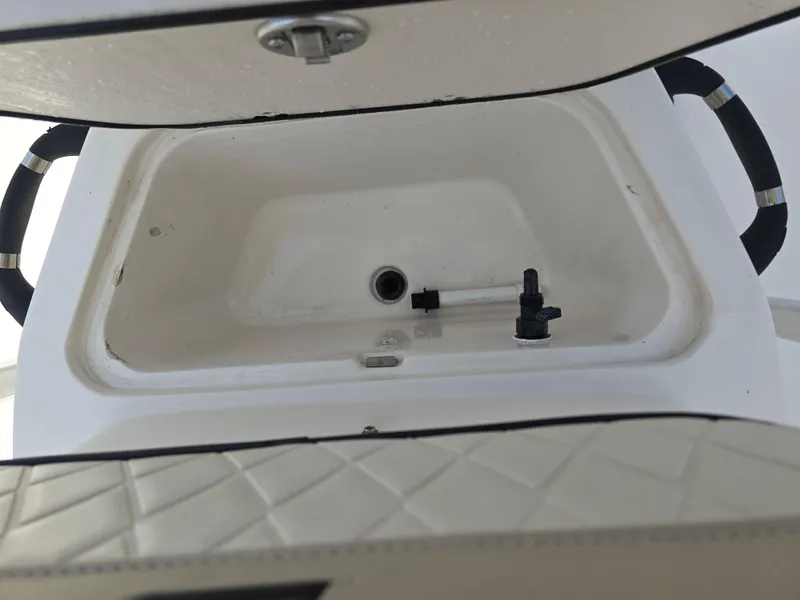Slide: The Image of 2021 Carolina Skiff 21 LS boat storage compartment with open lid and handles. - 7