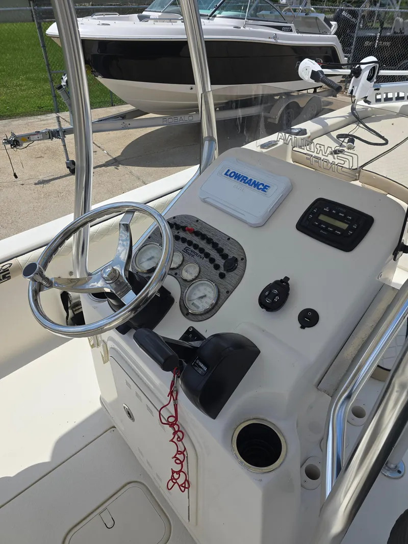Slide: The Image of 2021 Carolina Skiff 21 LS boat console with steering wheel and navigation equipment. - 8