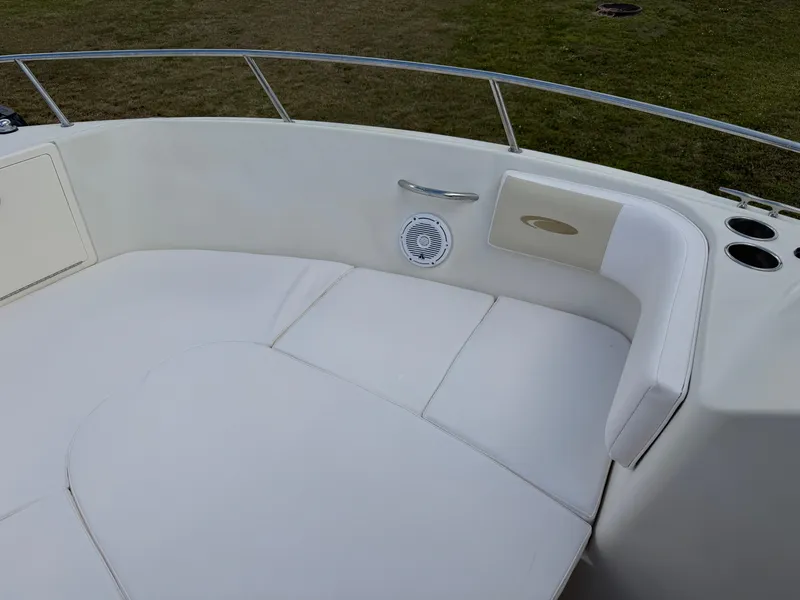 Slide: The Image of 2011 Cobia 215 Dual Console boat interior with white seating and speaker. - 10