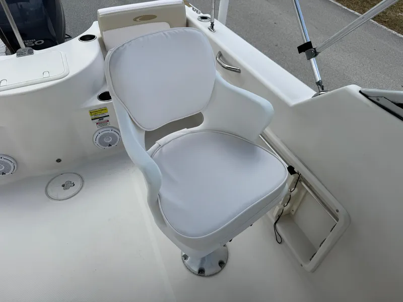 Slide: The Image of White captain's chair on 2011 Cobia 215 Dual Console boat deck. - 13
