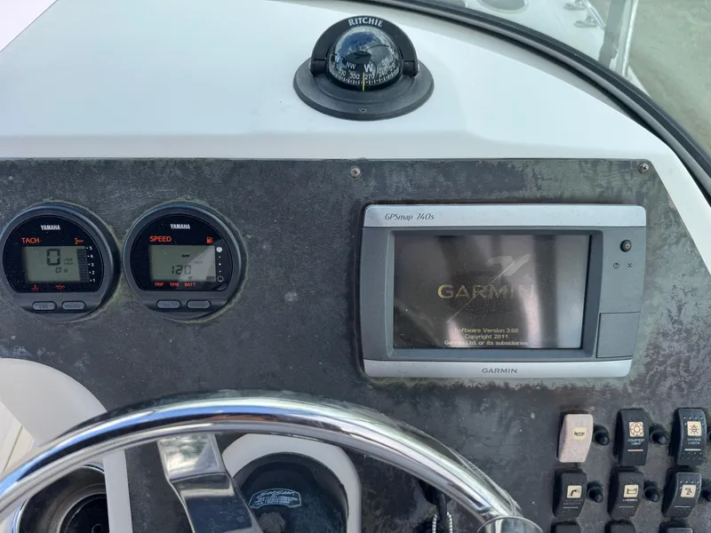 Slide: The Image of Dashboard of a 2011 Cobia 215 Dual Console boat with Garmin GPS and gauges. - 16