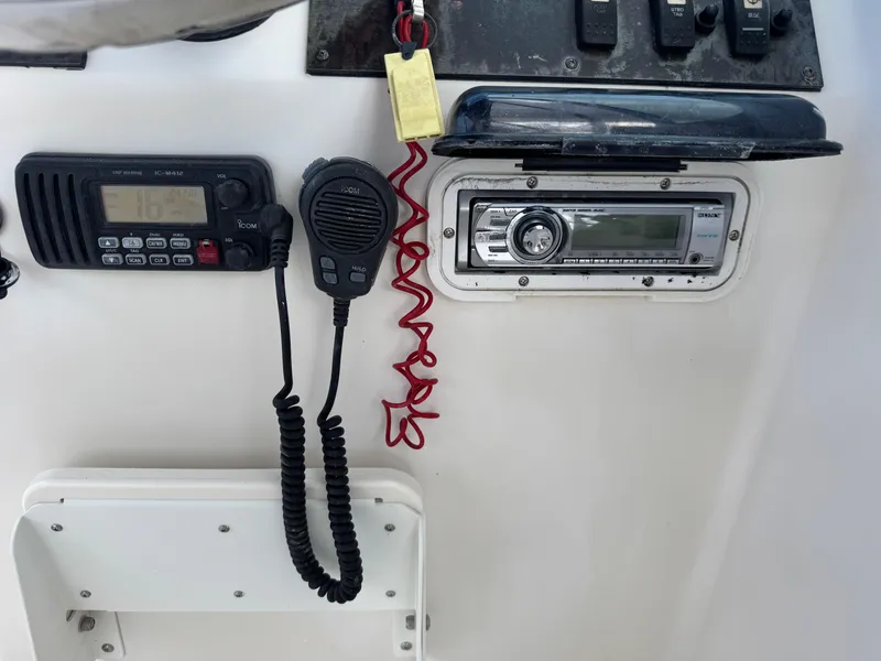 Slide: The Image of 2011 Cobia 215 Dual Console dashboard with radio and communication equipment. - 17