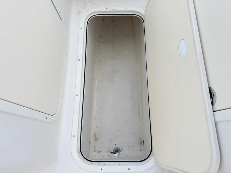 Slide: The Image of Open storage compartment on a 2011 Cobia 215 Dual Console boat. - 20