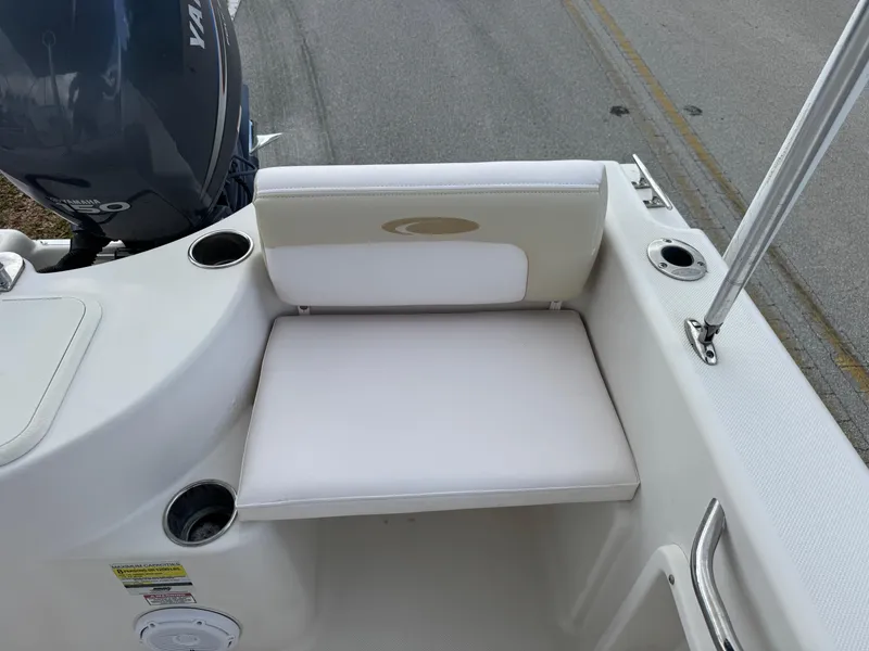 Slide: The Image of 2011 Cobia 215 Dual Console boat seat with cup holders and Yamaha engine. - 24
