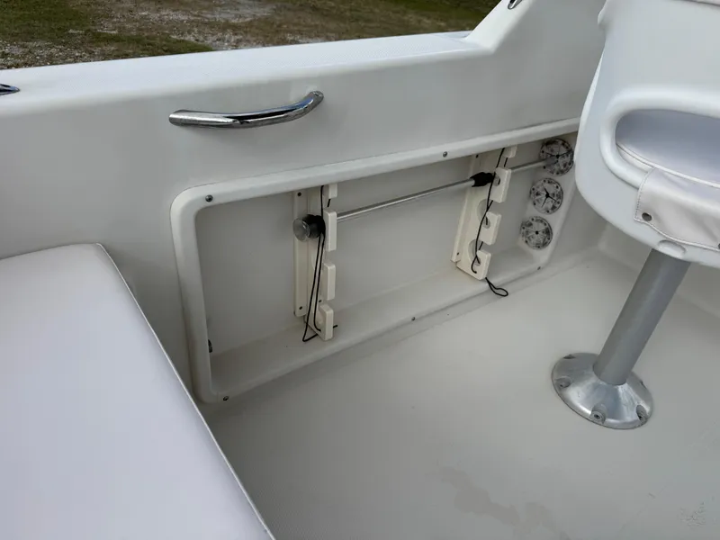 Slide: The Image of 2011 Cobia 215 Dual Console interior with seating and storage compartment. - 28