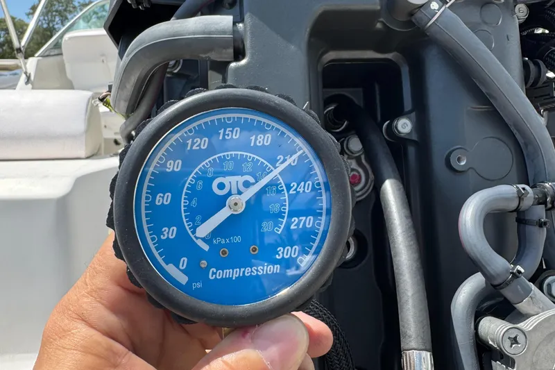 Slide: The Image of Compression gauge reading on a 2011 Cobia 215 Dual Console boat engine. - 32