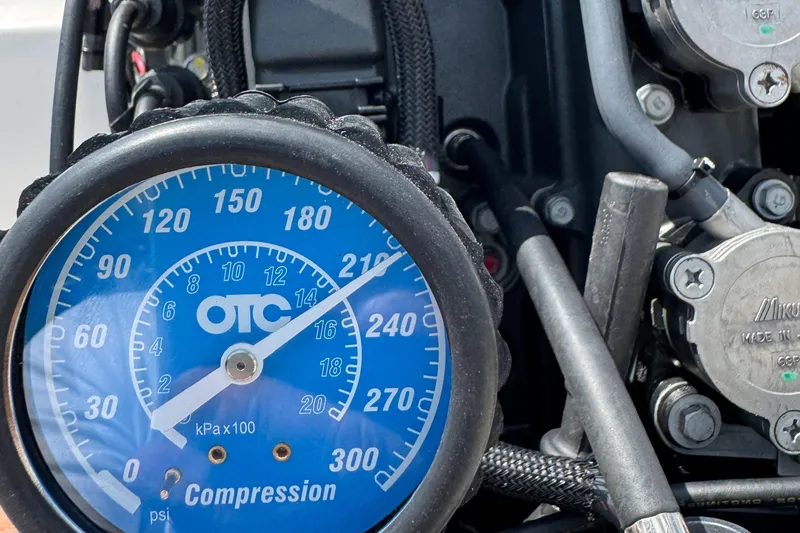 Slide: The Image of Compression gauge reading on a 2011 Cobia 215 Dual Console engine. - 34