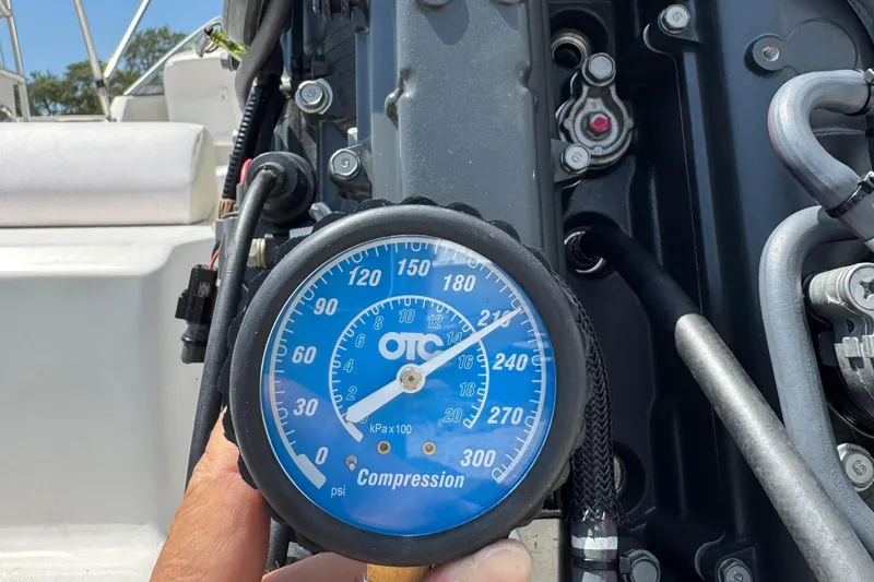 Slide: The Image of Compression gauge reading on a 2011 Cobia 215 Dual Console boat engine. - 35