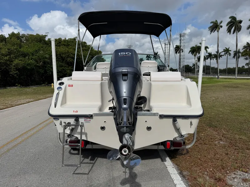 Slide: The Image of 2011 Cobia 215 Dual Console boat with outboard motor on a sunny day. - 4