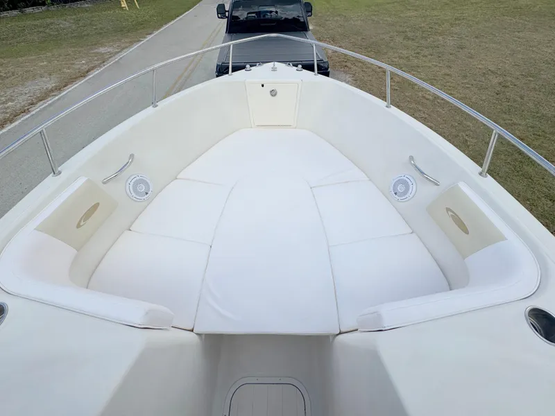 Slide: The Image of 2011 Cobia 215 Dual Console boat with spacious white seating area. - 8
