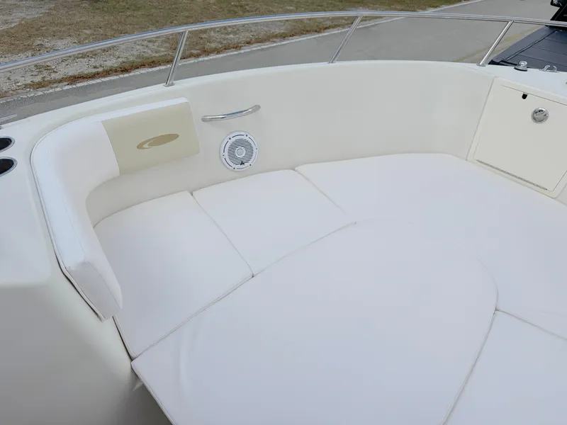 Slide: The Image of 2011 Cobia 215 Dual Console boat with white cushioned seating area. - 9