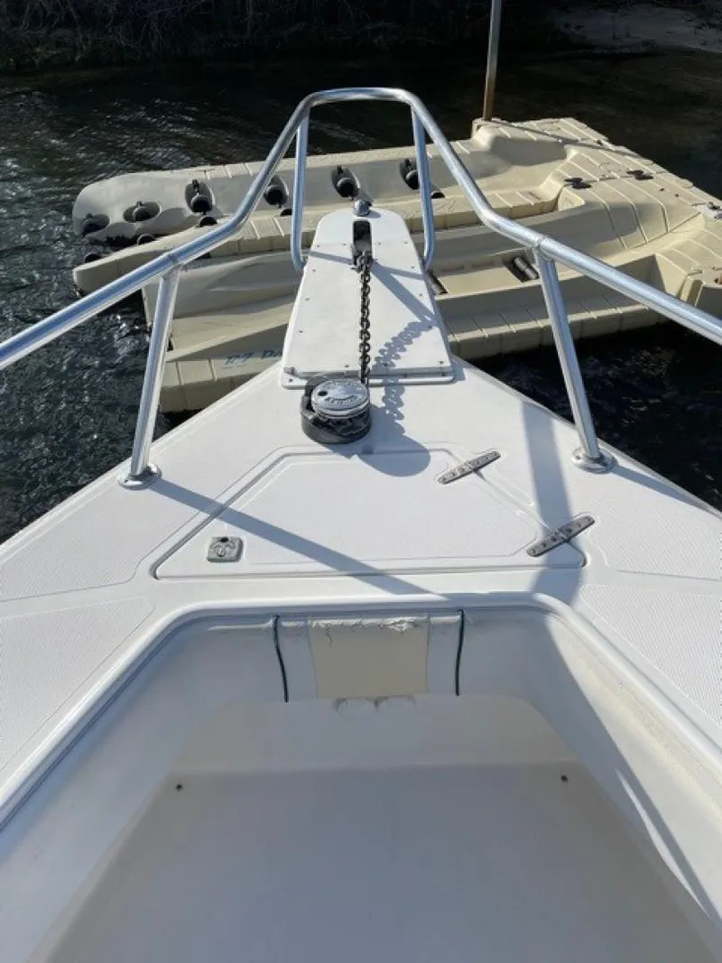 Slide: The Image of 2000 Venture 34 Center Console boat bow with anchor chain and railings. - 11
