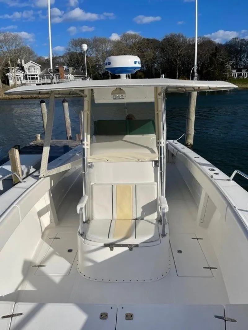 Slide: The Image of 2000 Venture 34 Center Console boat docked, featuring spacious deck and clear blue sky. - 12