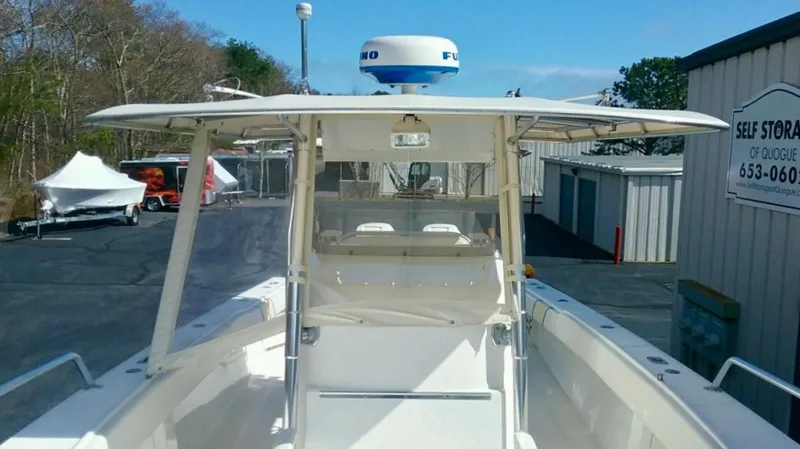 Slide: The Image of 2000 Venture 34 Center Console boat docked at a marina, featuring a radar system. - 13