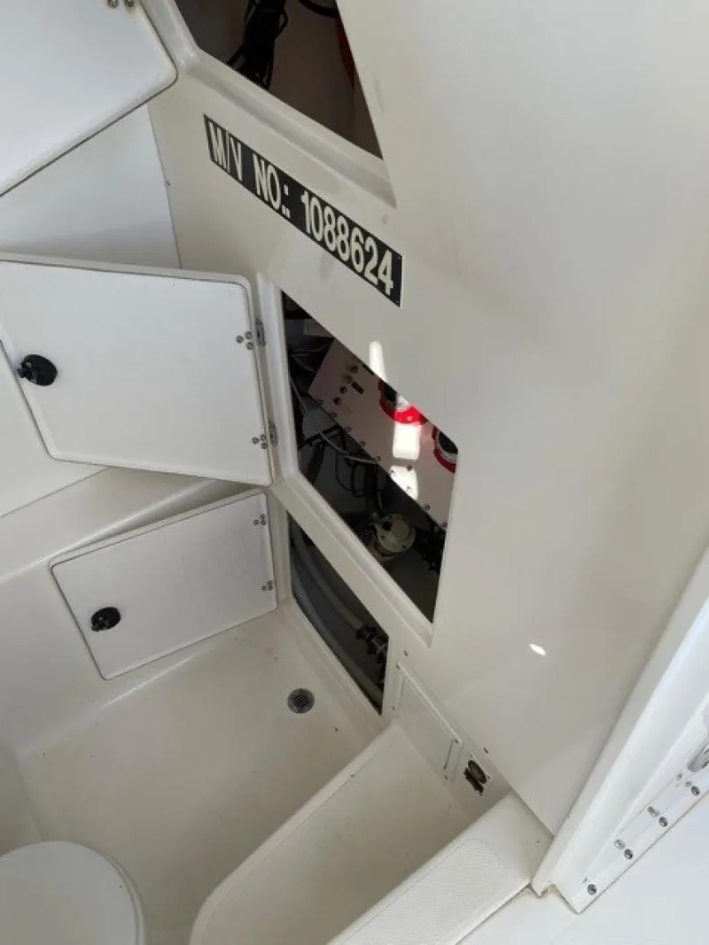 Slide: The Image of 2000 Venture 34 Center Console interior with storage compartments and visible wiring. - 16