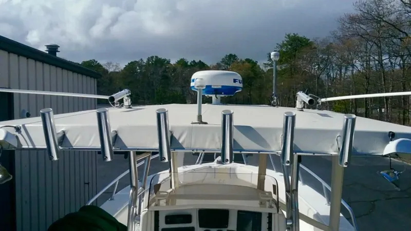 Slide: The Image of Venture 34 Center Console boat, 2000 model, with radar and rod holders, docked outdoors. - 17