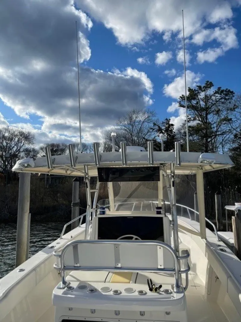 Slide: The Image of 2000 Venture 34 Center Console boat under a partly cloudy sky. - 18
