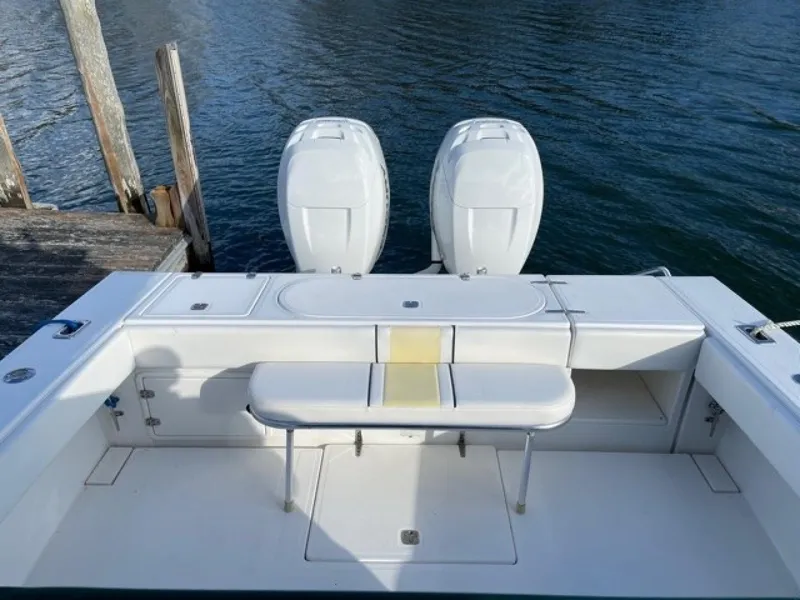 Slide: The Image of 2000 Venture 34 Center Console boat with dual engines, docked by the water. - 19